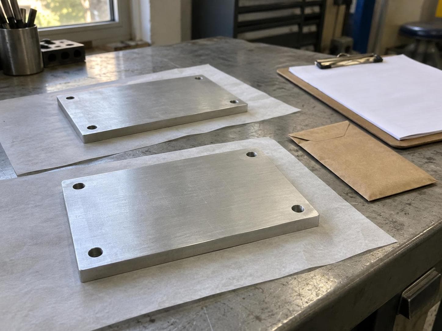 AI illustration of two generic aluminum plates on protective paper beside a blank preparation checklist.